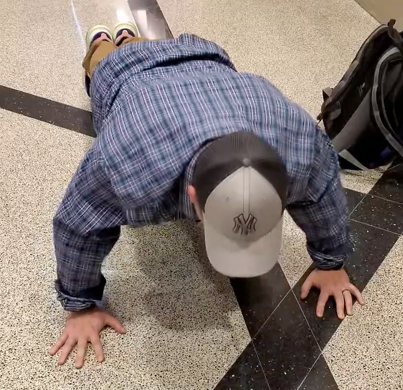 Performing push-ups in an airport setting