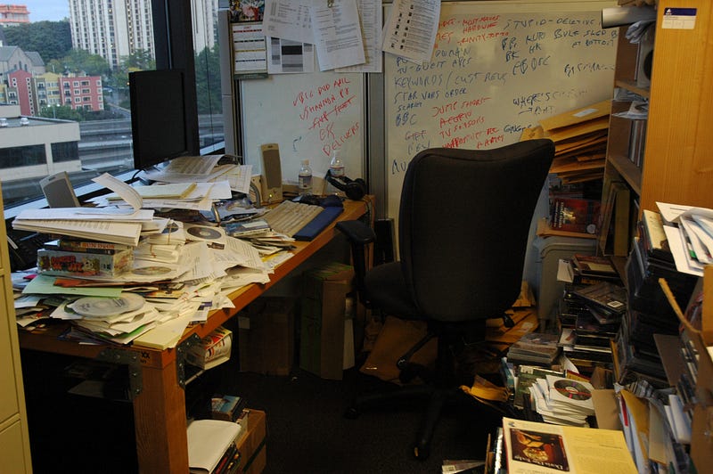 Disorganized workspace filled with notes