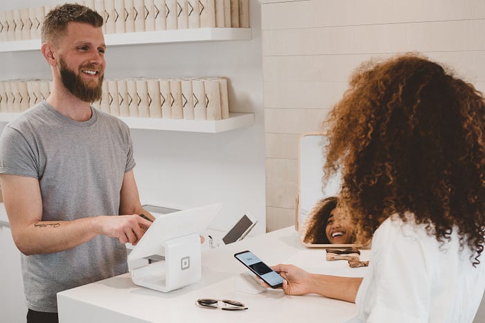 Cashier assisting customers at a store