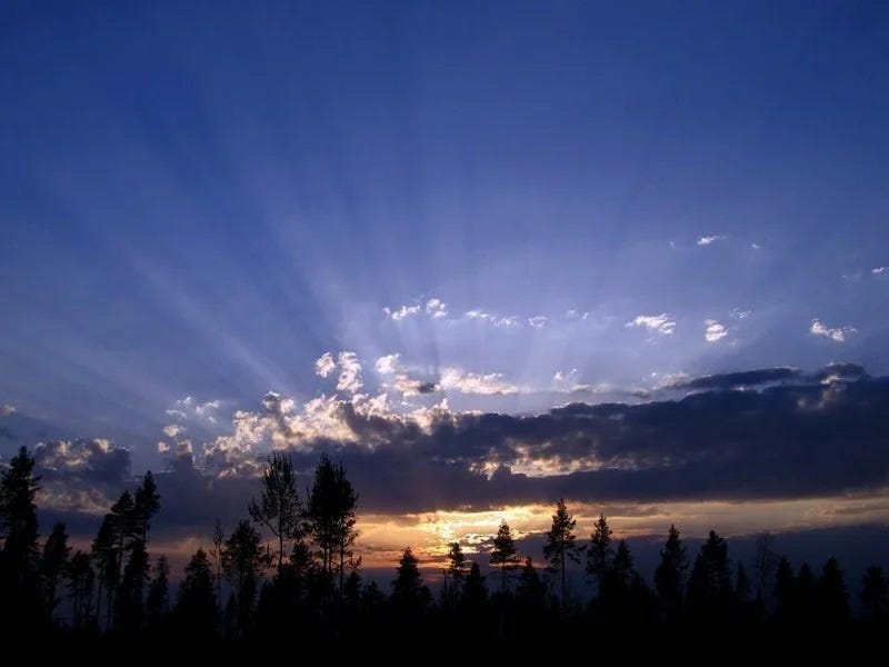 Sunbeams breaking through cloud gaps